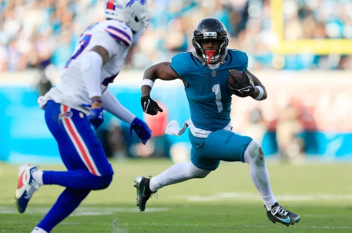 Jacksonville Jaguars running back Travis Etienne Jr. (1) rushes for yards against Buffalo Bills cornerback Christian Benford (47) during the fourth quarter of an NFL football AFC Wild Card playoff matchup, Sunday, Jan. 11, 2026, in Jacksonville, Fla. The Bills defeated the Jaguars 27-24. [Corey Perrine/Florida Times-Union]