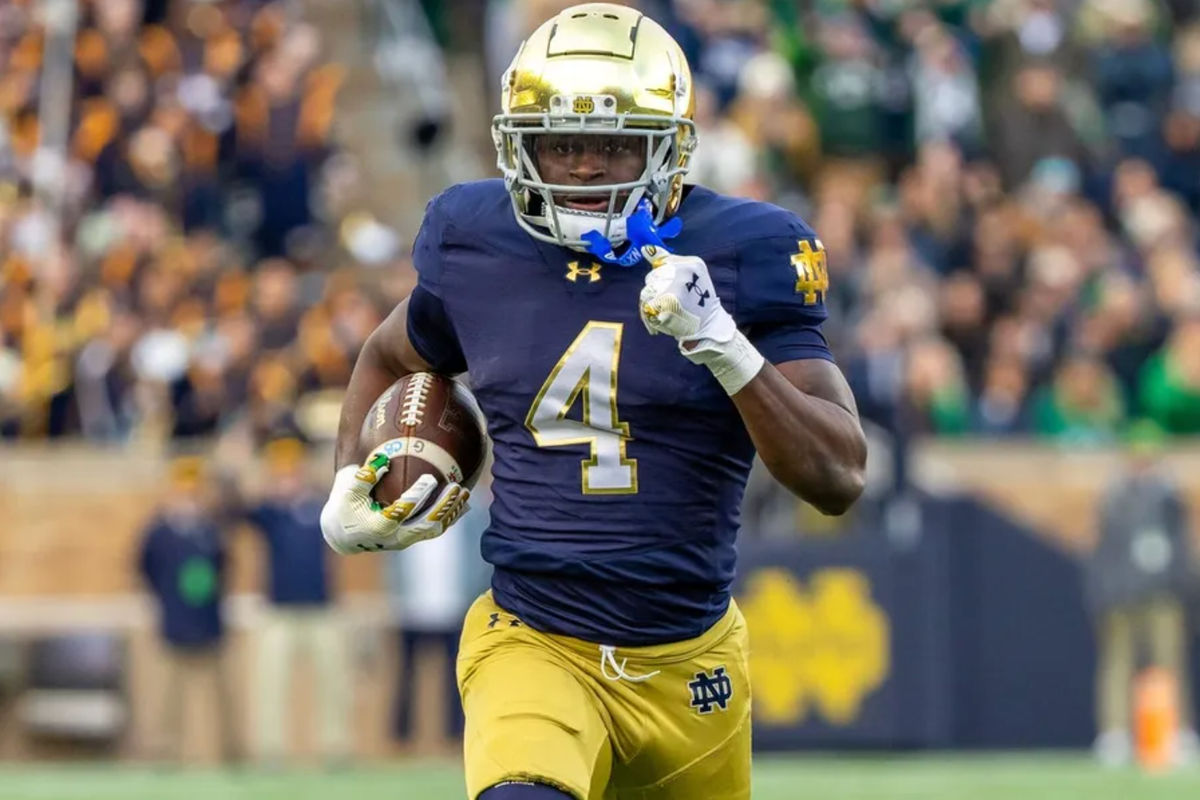 Nov 22, 2025; South Bend, Indiana, USA; Notre Dame Fighting Irish running back Jeremiyah Love (4) runs the ball against the Syracuse Orange during the first half at Notre Dame Stadium. Mandatory Credit: Michael Caterina-Imagn Images