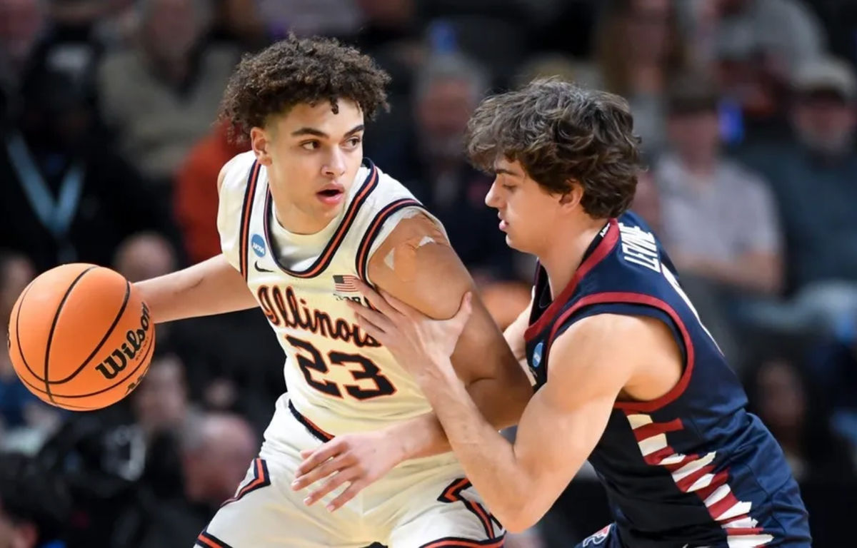 Illinois Fighting Illini guard Keaton Wagler (23) is defended by Penn Quakers guard AJ Levine (0) Thursday, March 19, 2026, during the NCAA Men’s Basketball Tournament first round game at Bon Secours Wellness Arena in Greenville, South Carolina.