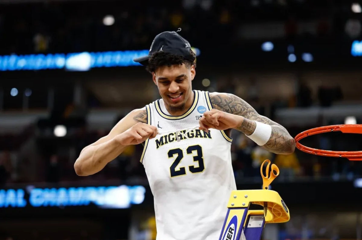 Mar 29, 2026; Chicago, IL, USA; Michigan Wolverines forward Yaxel Lendeborg (23) cuts the net after defeating Tennessee Volunteers in an Elite Eight game of the Midwest Regional of the men's 2026 NCAA Tournament at United Center. Mandatory Credit: Kamil Krzaczynski-Imagn Images