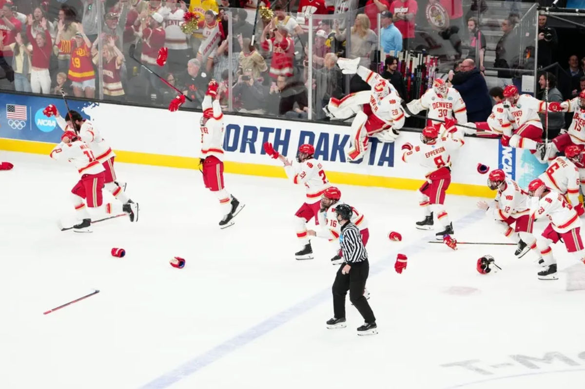 Apr 11, 2026; Las Vegas, Nevada, United States; The Denver Pioneers celebrate after defeating the Wisconsin Badgers in the championship game of the NCAA men's ice hockey Frozen Four at T-Mobile Arena. Mandatory Credit: Stephen R. Sylvanie-Imagn Images