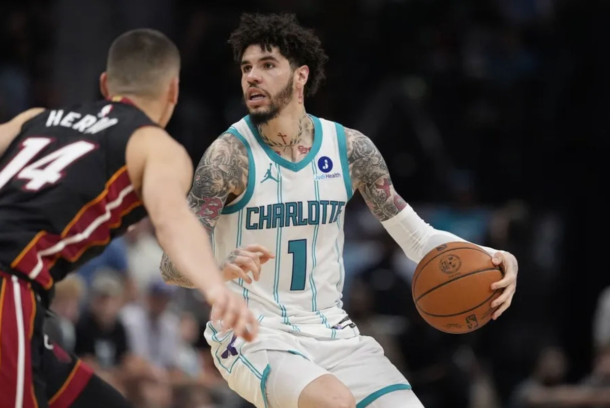 Apr 14, 2026; Charlotte, North Carolina, USA; Charlotte Hornets guard LaMelo Ball (1) looks to pass defended by Miami Heat guard Tyler Herro (14) during the second half during the play-in rounds between the Charlotte Hornets and the Miami Heat of the 2026 NBA Playoffs at Spectrum Center. Mandatory Credit: Jim Dedmon-Imagn Images