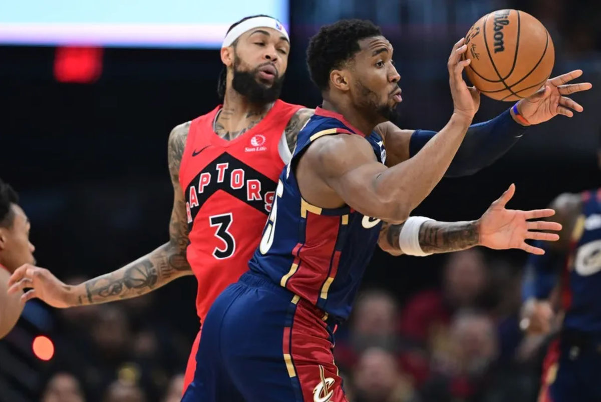 Apr 20, 2026; Cleveland, Ohio, USA; Cleveland Cavaliers guard Donovan Mitchell (45) passes while being defended by Toronto Raptors forward Brandon Ingram (3) during the first half during game two of the first round of the 2026 NBA Playoffs at Rocket Arena. Mandatory Credit: David Dermer-Imagn Images