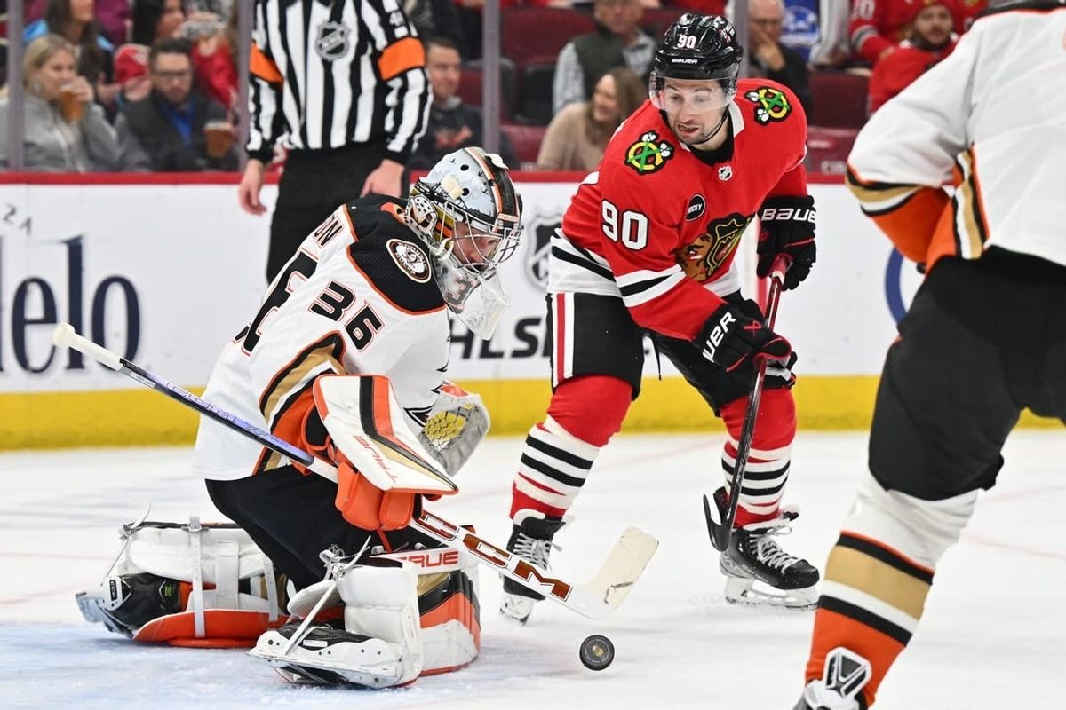 Mar 12, 2024; Chicago, Illinois, USA; Anaheim Ducks goaltender John Gibson (36) tracks a shot in the first period as Chicago Blackhawks forward Tyler Johnson (90) waits for the rebound at United Center.