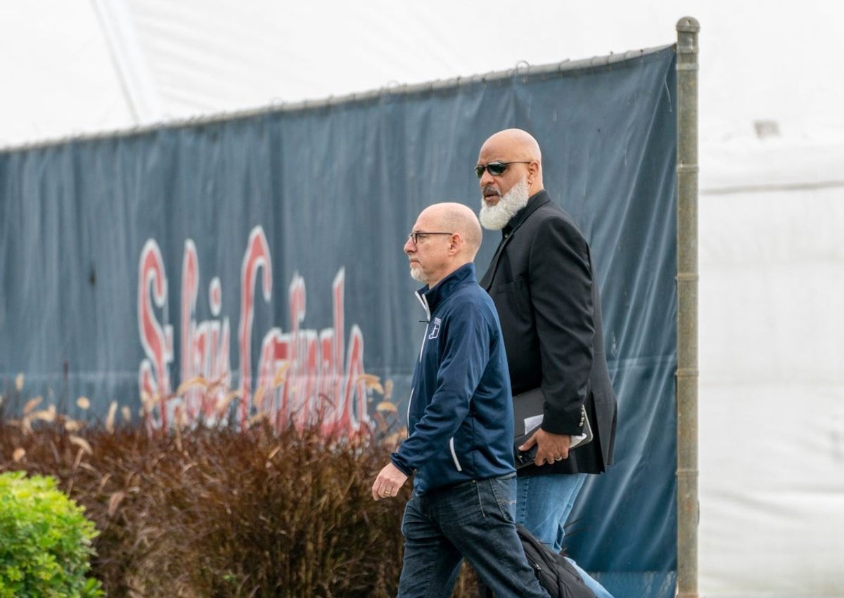 Major League Baseball Players Association executive director Tony Clark, right, and chief negotiator Bruce Meyer arrive for negotiations with the players union in an attempt to reach an agreement to salvage March 31 openers and a 162-game season, March 1, 2022, at Roger Dean Stadium in Jupiter, Florida.