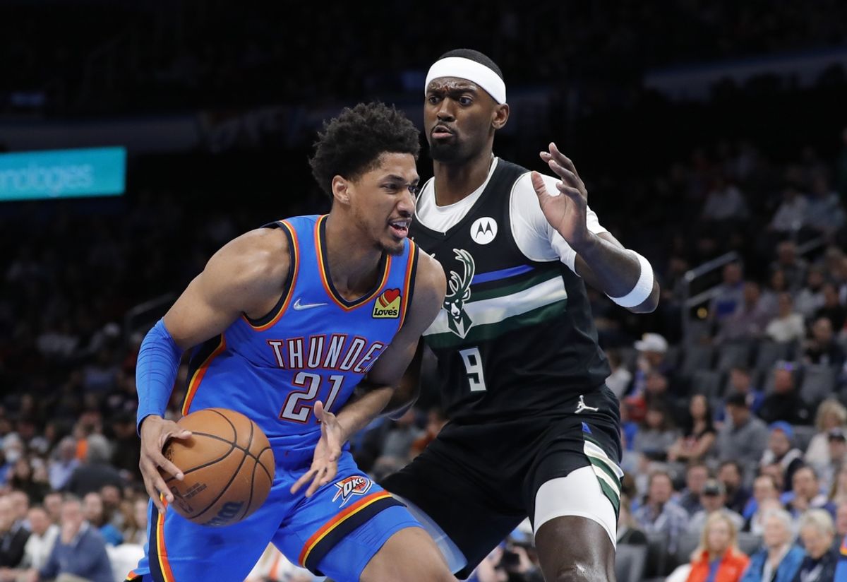 Mar 8, 2022; Oklahoma City, Oklahoma, USA; Oklahoma City Thunder guard Aaron Wiggins (21) goes to the basket as Milwaukee Bucks center Bobby Portis Jr. (9) defends the play during the first quarter at Paycom Center. Mandatory Credit: Alonzo Adams-Imagn Images