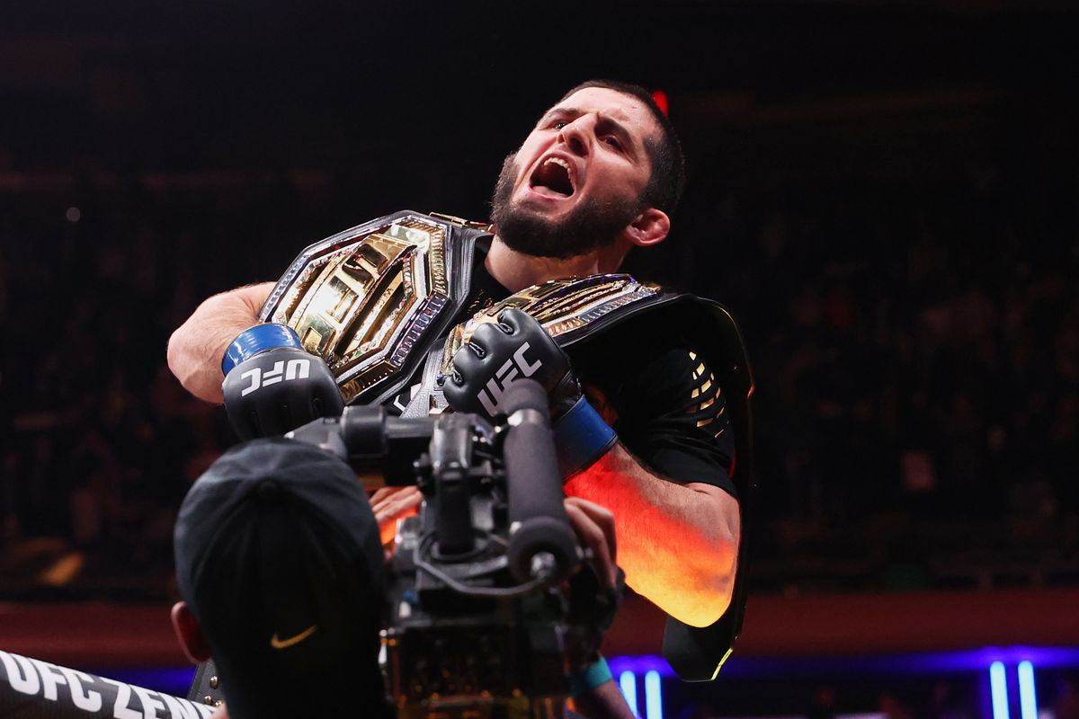 Nov 15, 2025; New York, NY, UNITED STATES; Islam Makhachev (blue gloves) celebrates after defeating Jack Della Maddalena (not pictured) by unanimous decision in the welterweight championship bout during UFC 322 at Madison Square Garden. Mandatory Credit: Ed Mulholland-Imagn Images