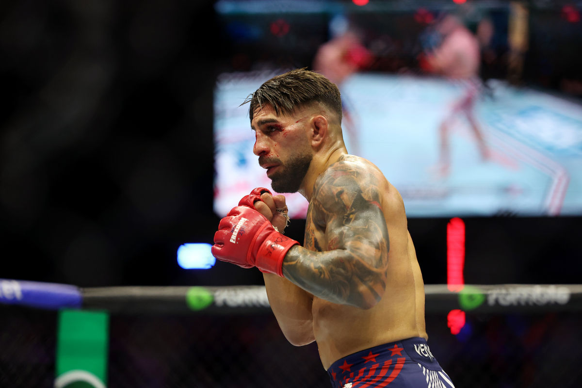 Jun 14, 2026; Washington, D.C., USA; Ilia Topuria (red gloves) fights Justin Gaethje (not pictured) during UFC Freedom 250 at White House South Lawn. Mandatory Credit: Amber Searls-Imagn Images