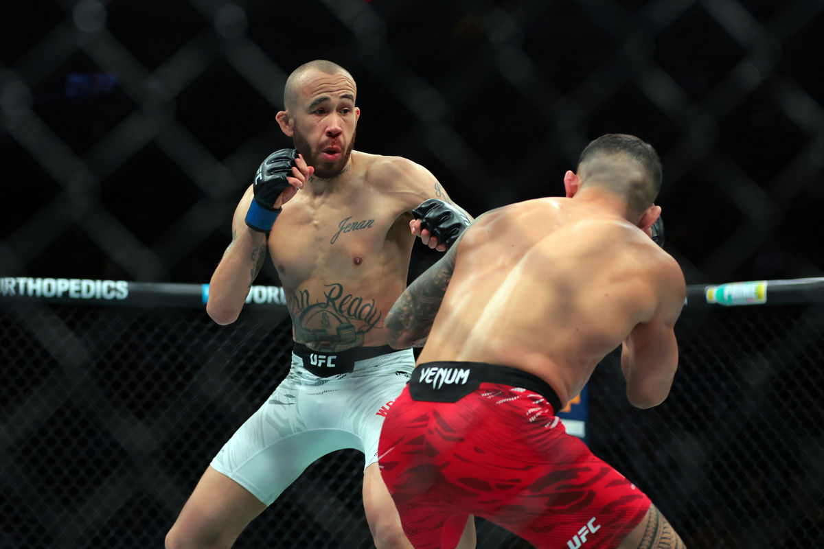 Apr 12, 2025; Miami, Florida, UNITED STATES; Dan Ige (red gloves) fights against Sean Woodson (blue gloves) during UFC 314 at Kaseya Center. Mandatory Credit: Sam Navarro-Imagn Images