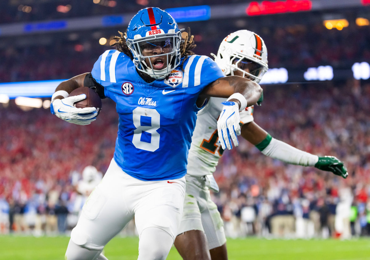 Jan 8, 2026; Glendale, AZ, USA; Mississippi Rebels tight end Dae'Quan Wright (8) scores a touchdown against the Miami Hurricanes during the 2026 Fiesta Bowl and semifinal game of the College Football Playoff at State Farm Stadium. Mandatory Credit: Mark J. Rebilas-Imagn Images