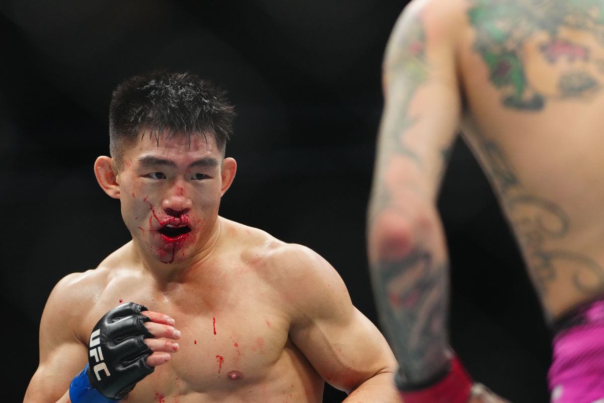 Jan 24, 2026; Las Vegas, Nevada, USA; Sean O’Malley (red gloves) fights Song Yadong (blue gloves) during UFC 324 at T-Mobile Arena. Mandatory Credit: Stephen R. Sylvanie-Imagn Images