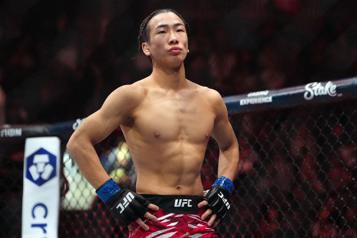 Mar 8, 2025; Las Vegas, Nevada, USA; Rei Tsuruya (blue gloves) prepares to fight Joshua Van (not pictured) during UFC 313 at T-Mobile Arena. Mandatory Credit: Stephen R. Sylvanie-Imagn Images
