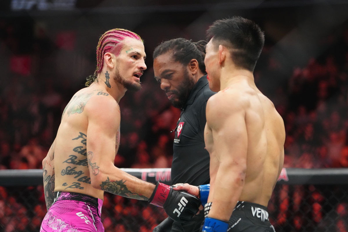 Jan 24, 2026; Las Vegas, Nevada, USA; Sean OÕMalley (red gloves) greets Song Yadong (blue gloves) after their fight during UFC 324 at T-Mobile Arena. Mandatory Credit: Stephen R. Sylvanie-Imagn Images