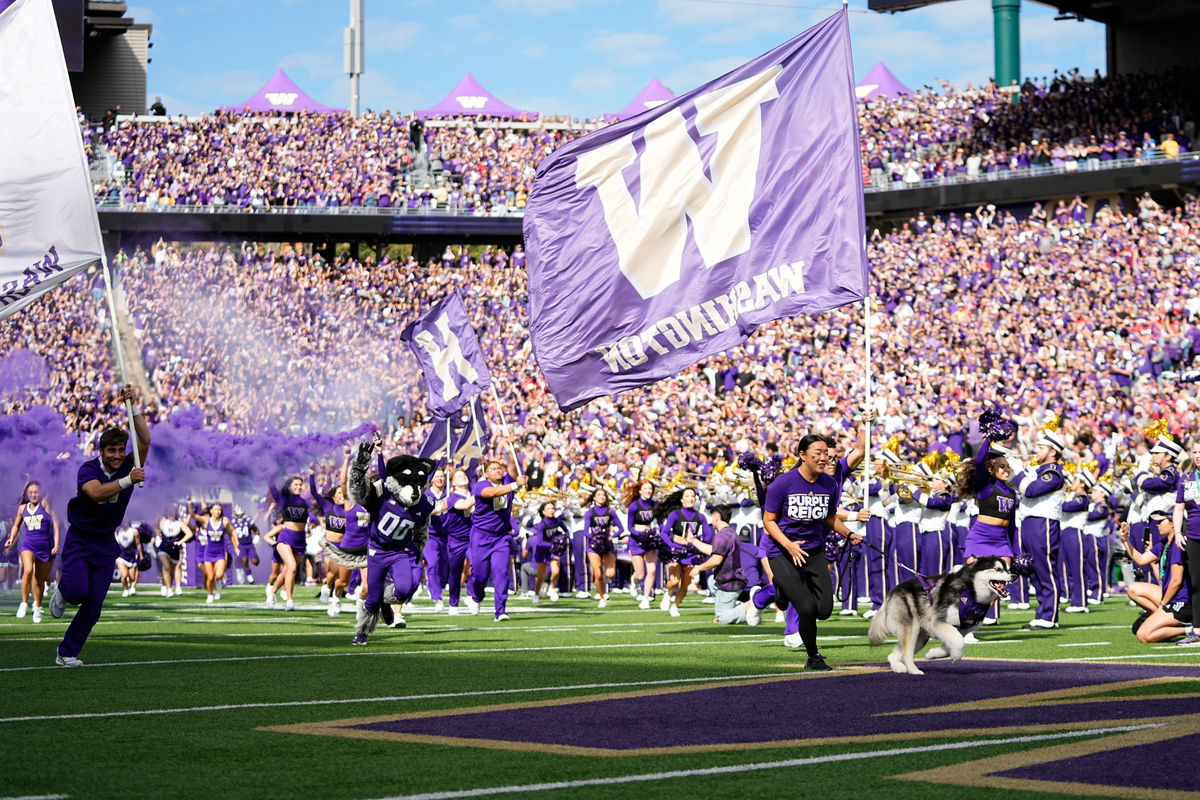 The Washington Huskies take the field prior to the NCAA football game against the Ohio State Buckeyes at Husky Stadium in Seattle on Sept. 27, 2025.