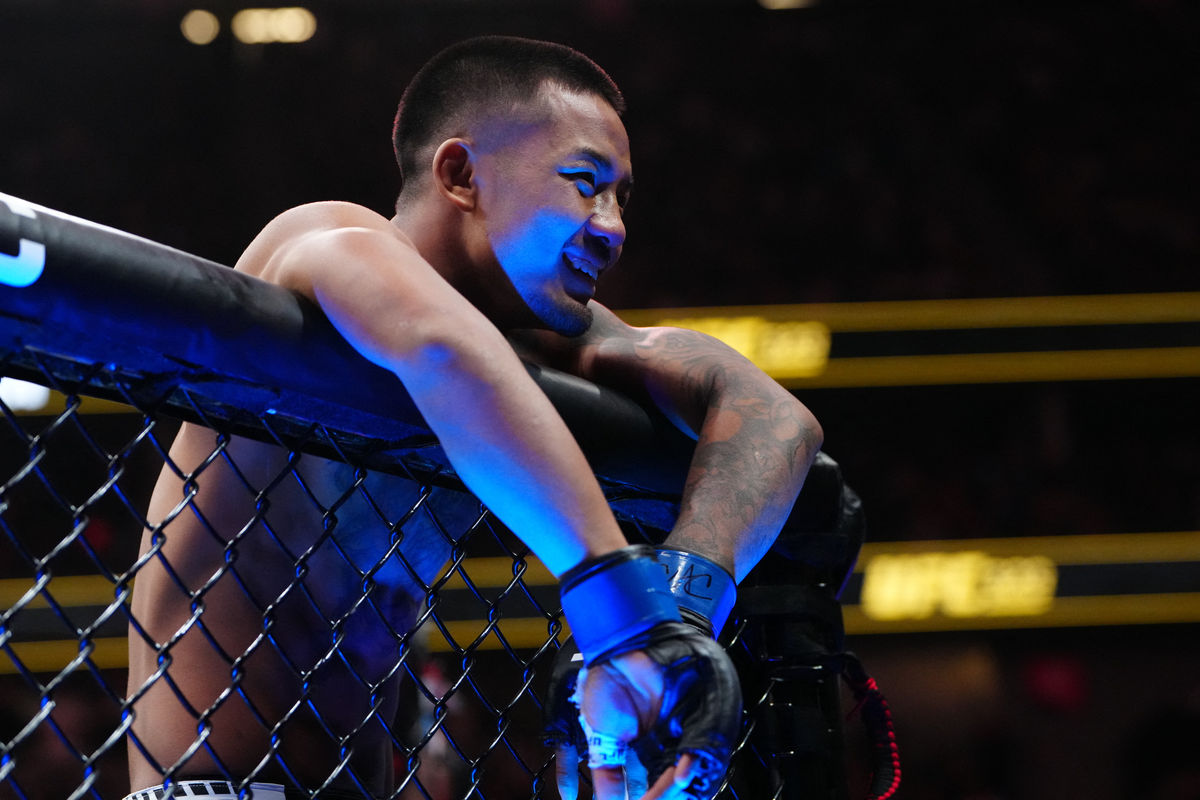 Dec 6, 2025; Las Vegas, Nevada, UNITED STATES; Joshua Van (blue gloves) reacts after the fight against Alexandre Pantoja (red gloves) during UFC 323 at T-Mobile Arena. Mandatory Credit: Stephen R. Sylvanie-Imagn Images