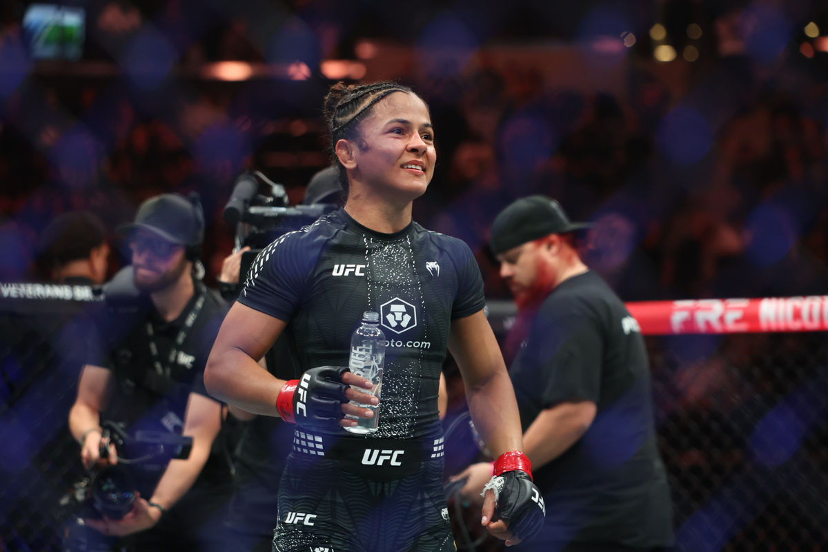 Oct 3, 2026; Salt Lake City, Utah, USA; Natalia Silva (red gloves) celebrates after the fight against Wang Cong (blue gloves) during UFC 332 at Delta Center. Mandatory Credit: Rob Gray-Imagn Images