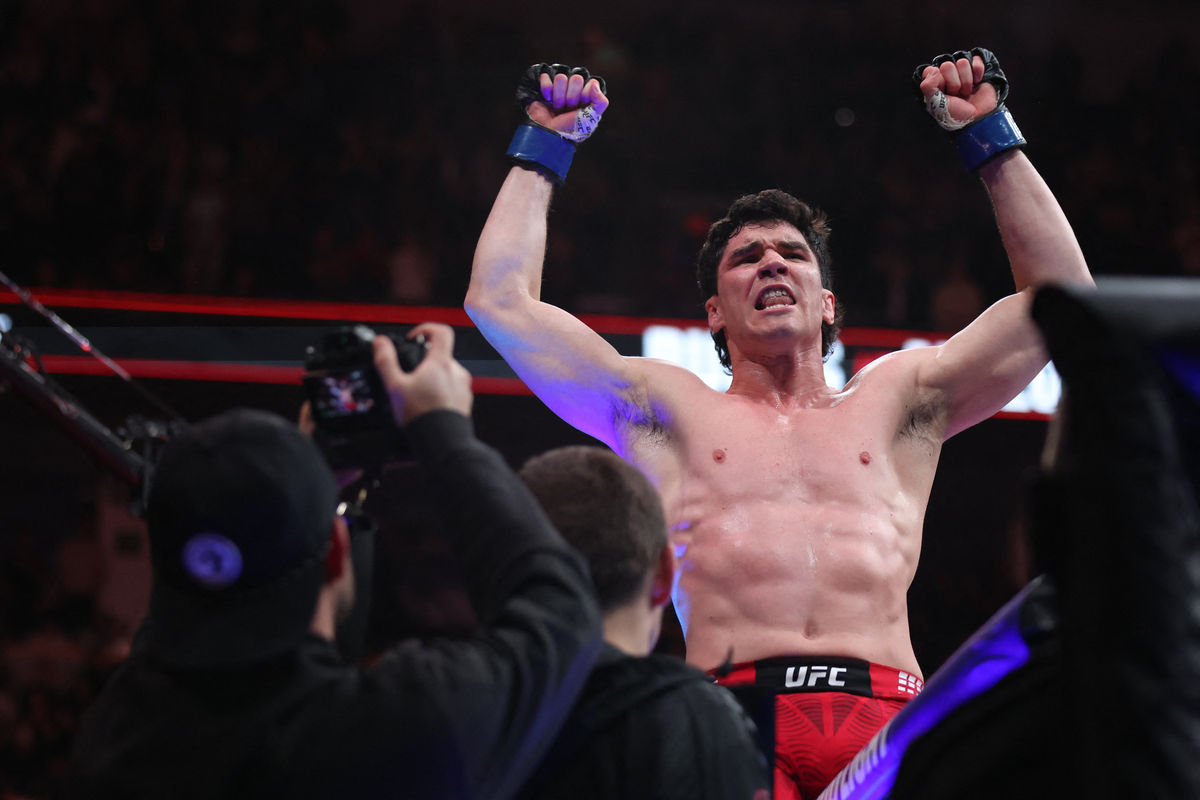 Apr 18, 2026; Winnipeg, Manitoba, CANADA; Mike Malott (blue gloves) reacts after defeating Gilbert Burns (red gloves) during UFC Fight Night at Canada Life Centre. Mandatory Credit: Bruce Fedyck-Imagn Images