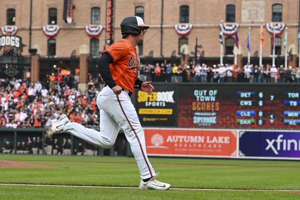 Mar 30, 2024; Baltimore, Maryland, USA;  Baltimore Orioles catcher Adley Rutschman (35) scores on  first baseman Ryan Mountcastle (not pictured) first inning double against the Los Angeles Angels at Oriole Park at Camden Yards.