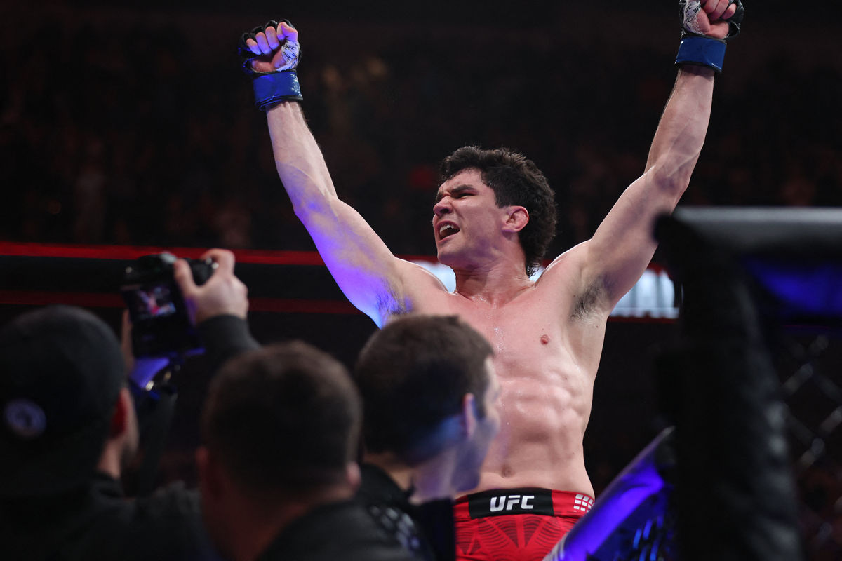 Apr 18, 2026; Winnipeg, Manitoba, CANADA; Mike Malott (blue gloves) reacts after defeating Gilbert Burns (red gloves) during UFC Fight Night at Canada Life Centre. Mandatory Credit: Bruce Fedyck-Imagn Images
