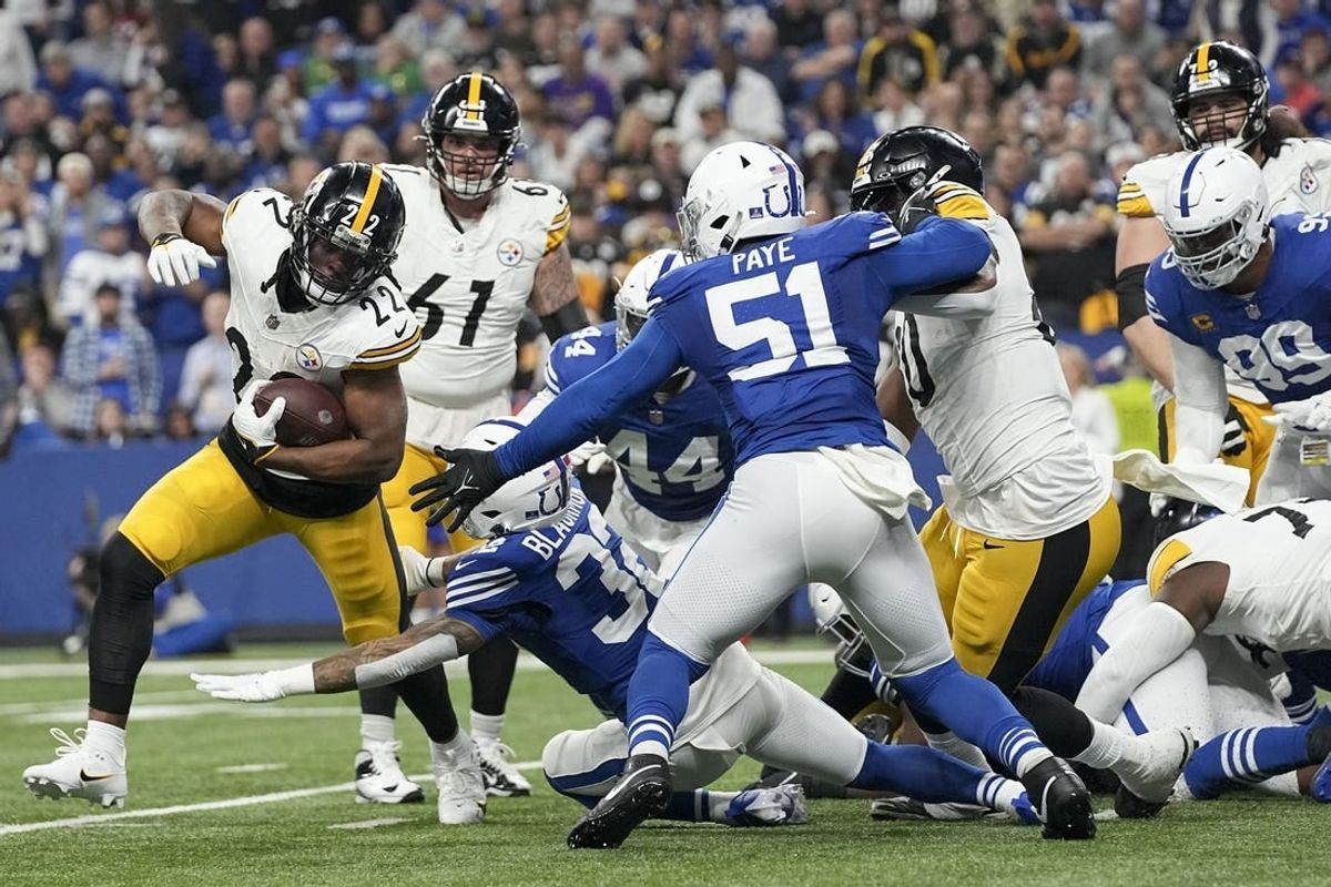 Dec 16, 2023; Indianapolis, Indiana, USA; Indianapolis Colts defensive end Kwity Paye (51) moves in to tackle Pittsburgh Steelers running back Najee Harris (22) for a loss during a game against the Pittsburgh Steelers at Lucas Oil Stadium.