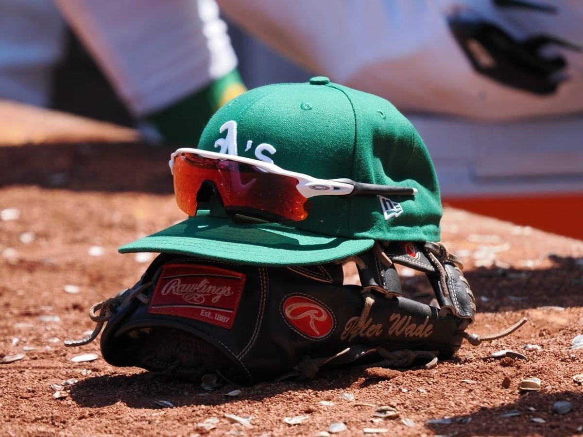 Jun 29, 2023; Oakland, California, USA; An Oakland Athletics hat on top of a glove during the eighth inning at Oakland-Alameda County Coliseum.