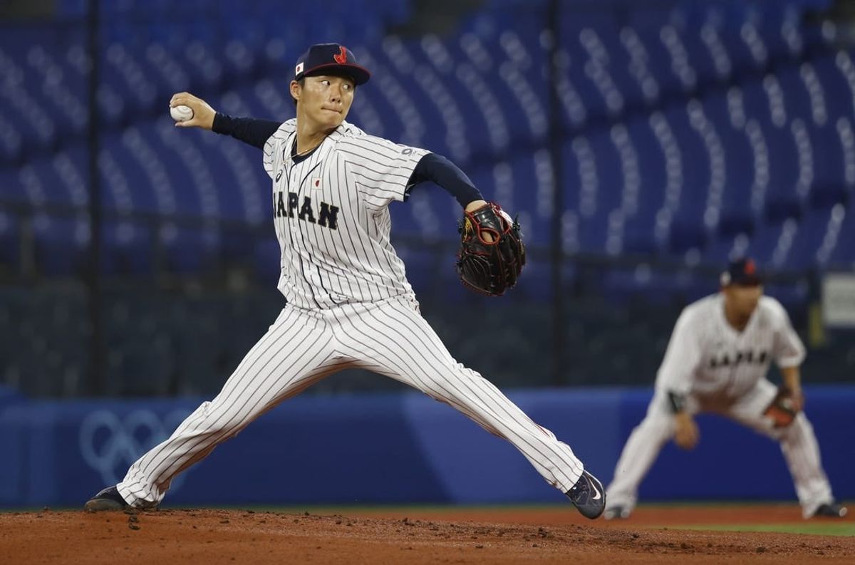 Aug 4, 2021; Yokohama, Japan; Team Japan pitcher Yoshinobu Yamamoto (17) throws a pitch against Korea in a baseball semifinal match during the Tokyo 2020 Olympic Summer Games at Yokohama Baseball Stadium.