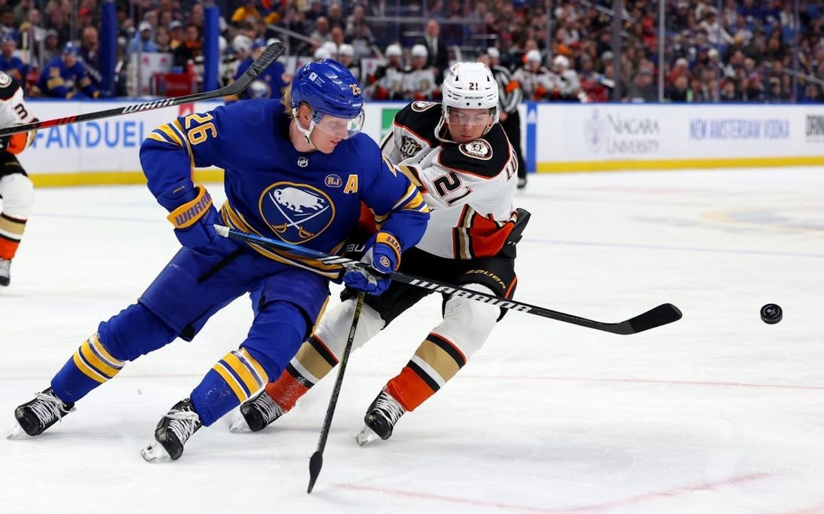 Feb 19, 2024; Buffalo, New York, USA;  Buffalo Sabres defenseman Rasmus Dahlin (26) clears the puck as Anaheim Ducks center Isac Lundestrom (21) defends during the first period at KeyBank Center.