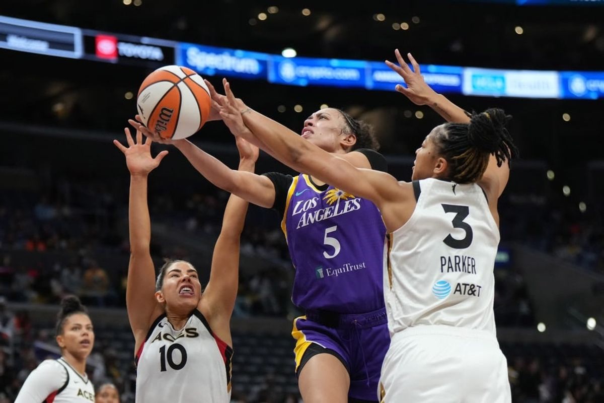 May 25, 2023; Los Angeles, California, USA; LA Sparks guard Dearica Hamby (5) shoots the ball against Las Vegas Aces forward Candace Parker (3) and guard Kelsey Plum (10) during the first half at Crypto.com Arena.