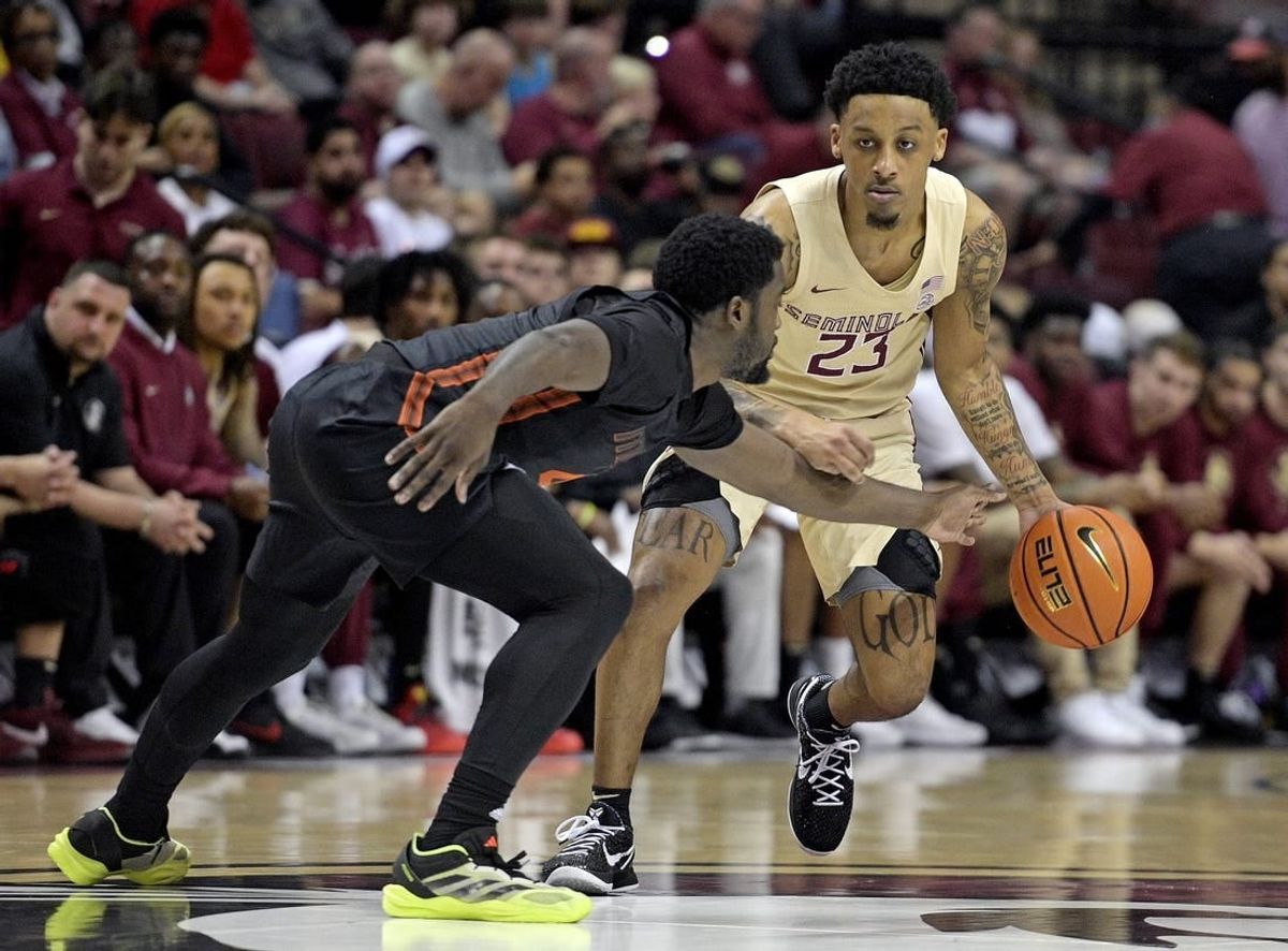 Mar 9, 2024; Tallahassee, Florida, USA; Florida State Seminoles guard Primo Spears (23) controls the ball against Miami Hurricanes guard Bensley Joseph (4) during the first half at Donald L. Tucker Center.
