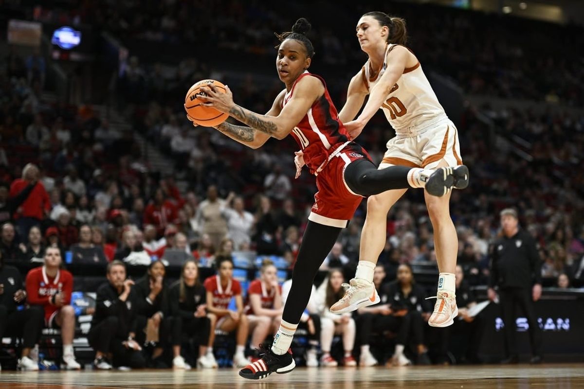 Mar 31, 2024; Portland, OR, USA; NC State Wolfpack guard Aziaha James (10) grabs a rebound during the first half against Texas Longhorns guard Shay Holle (10) in the finals of the Portland Regional of the NCAA Tournament at the Moda Center center.