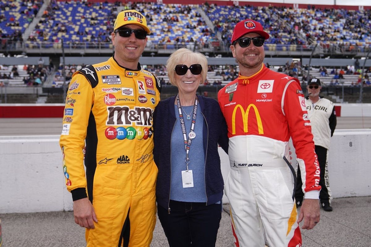 May 8, 2022; Darlington, South Carolina, USA; NASCAR Cup Series driver Kyle Busch (L) poses for a picture with his mother Gaye Busch (C) and brother Kurt Busch (R) on pit road prior to the Goodyear 400 at Darlington Raceway. Mandatory Credit: Jasen Vinlove-Imagn Images