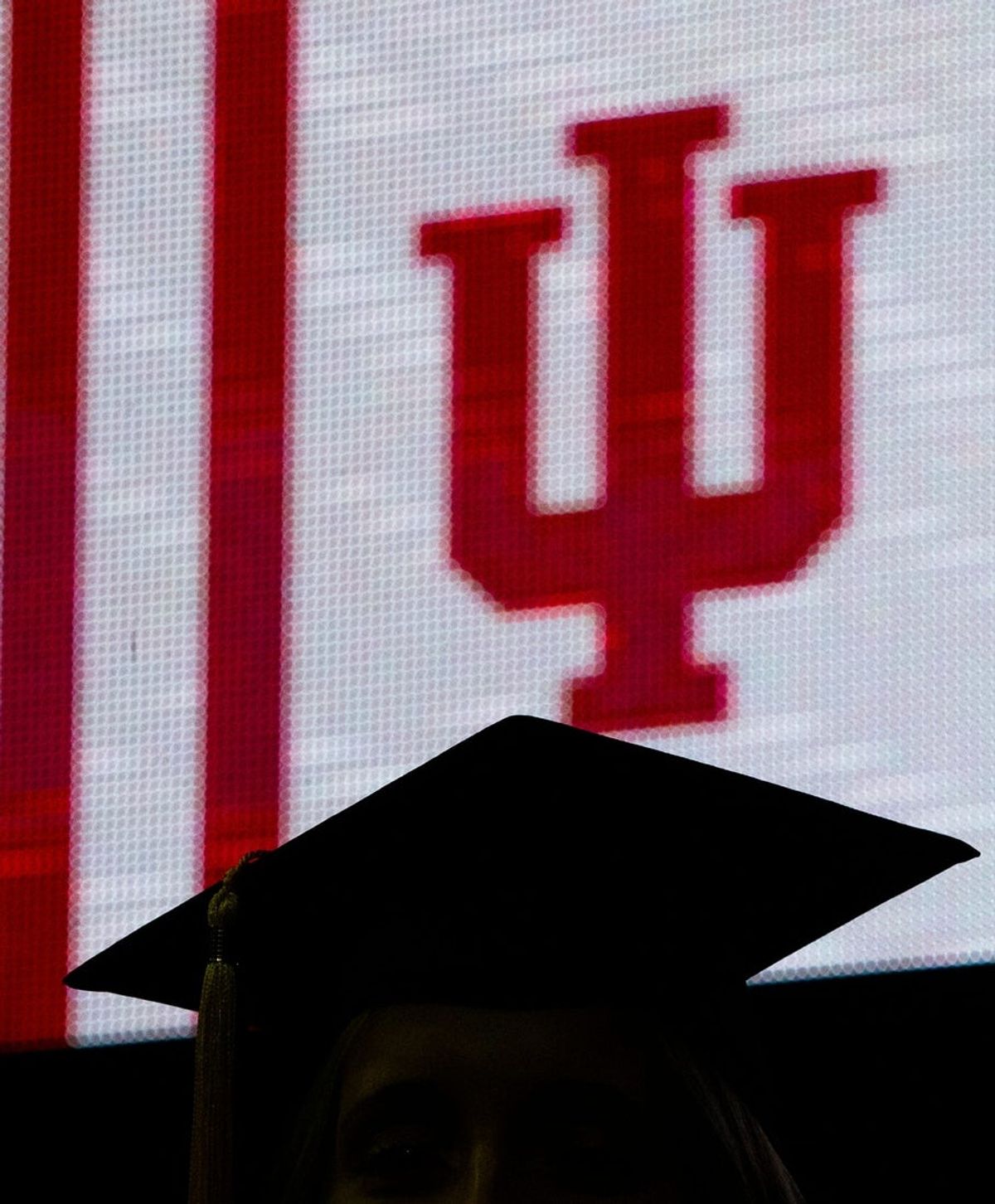 A graduate walks past the IU logo during the IUSB Commencement ceremony Tuesday, May 10, 2022 at the Joyce Center in South Bend.

Iusb Commencement