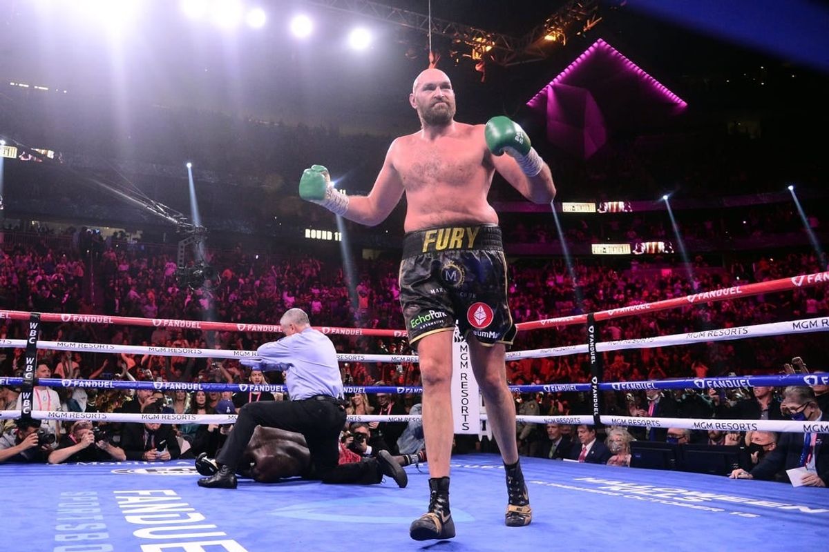 Oct 9, 2021; Las Vegas, Nevada, USA; Deontay Wilder (red/black trunks) is knocked out by Tyson Fury (black/gold trunks) during their WBC/Lineal heavyweight championship boxing match at T-Mobile Arena.