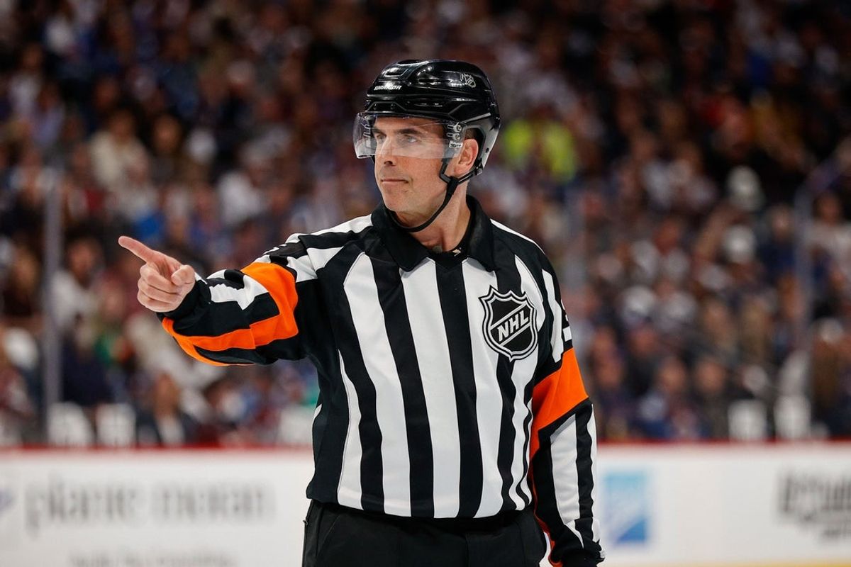 May 25, 2022; Denver, Colorado, USA; Referee Chris Rooney (5) gestures in the first period between the Colorado Avalanche and the St. Louis Blues in game five of the second round of the 2022 Stanley Cup Playoffs at Ball Arena. Mandatory Credit: Isaiah J. Downing-Imagn Images