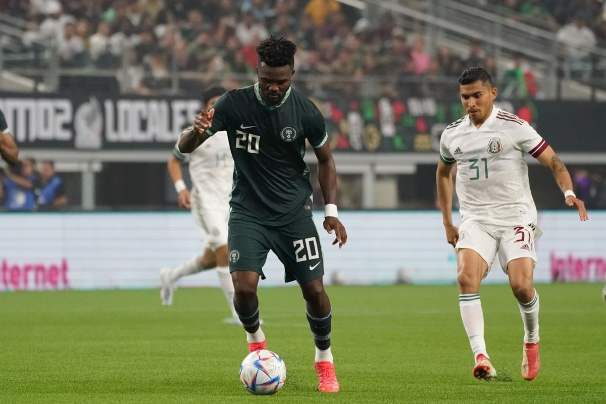 May 28, 2022; Arlington, TX, USA; Nigeria defender Chidozie Awaziem (20) controls the ball against Mexico midfielder Orbelin Pineda (31) during the second half at AT&T Stadium. Mandatory Credit: Chris Jones-USA TODAY Sports