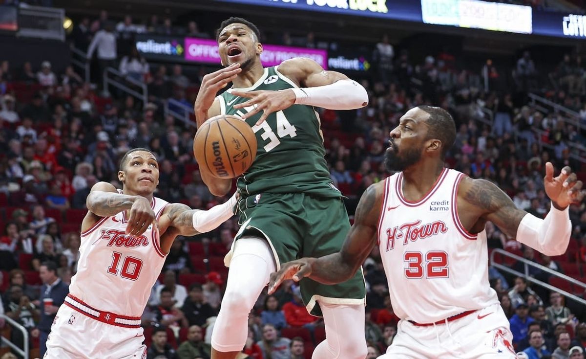 Jan 6, 2024; Houston, Texas, USA; Milwaukee Bucks forward Giannis Antetokounmpo (34) attempts to control the ball as Houston Rockets forward Jabari Smith Jr. (10) defends during the second quarter at Toyota Center.