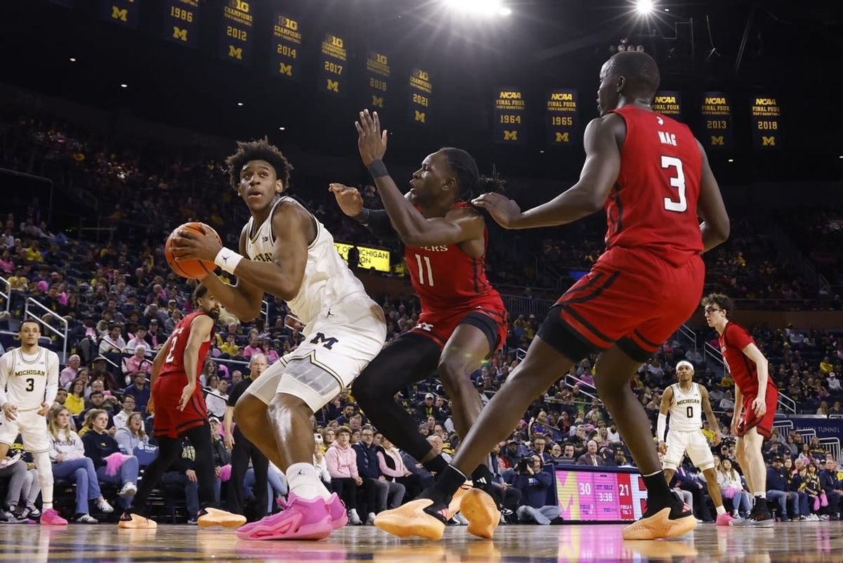 Feb 3, 2024; Ann Arbor, Michigan, USA;  Michigan Wolverines forward Tarris Reed Jr. (32) is defended by Rutgers Scarlet Knights center Clifford Omoruyi (11) in the first half at Crisler Center.