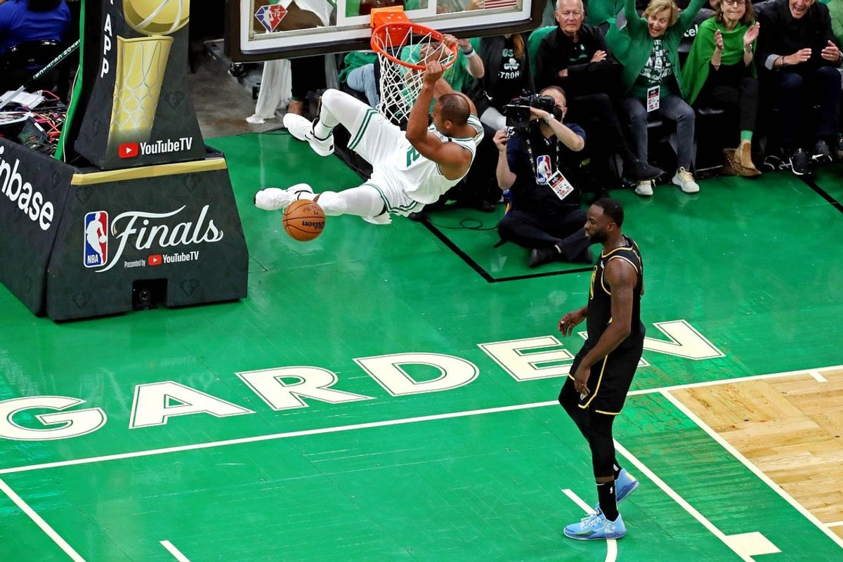 Jun 8, 2022; Boston, Massachusetts, USA; Boston Celtics center Al Horford (42) dunks the ball against Golden State Warriors forward Draymond Green (23) during the first quarter in game three of the 2022 NBA Finals at TD Garden. Mandatory Credit: Paul Rutherford-Imagn Images