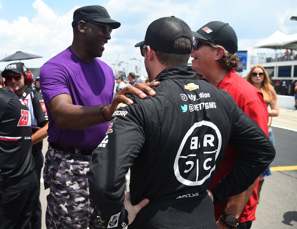 Jun 25, 2022; Nashville, Tennessee, USA; NASCAR Cup Series 23XI Racing owner Michael Jordan talks with driver Ty Dillon (42) on pit road during qualifying for the Ally 400 at Nashville Superspeedway. Mandatory Credit: Christopher Hanewinckel-Imagn Images