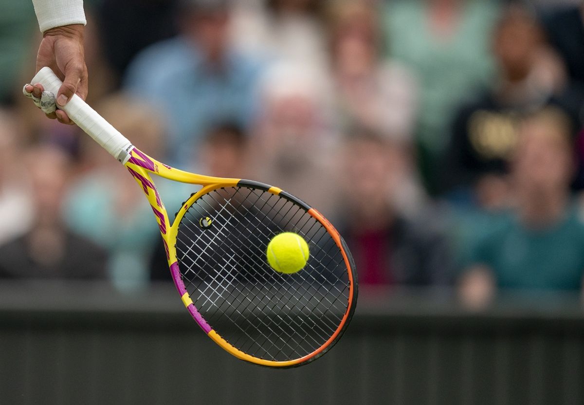 Jun 30, 2022; London, United Kingdom; A detail view of a ball on the racket of Rafael Nadal (ESP) during his match against Ricardas Berankis (LTU) on day four at All England Lawn Tennis and Croquet Club. Mandatory Credit: Susan Mullane-Imagn Images