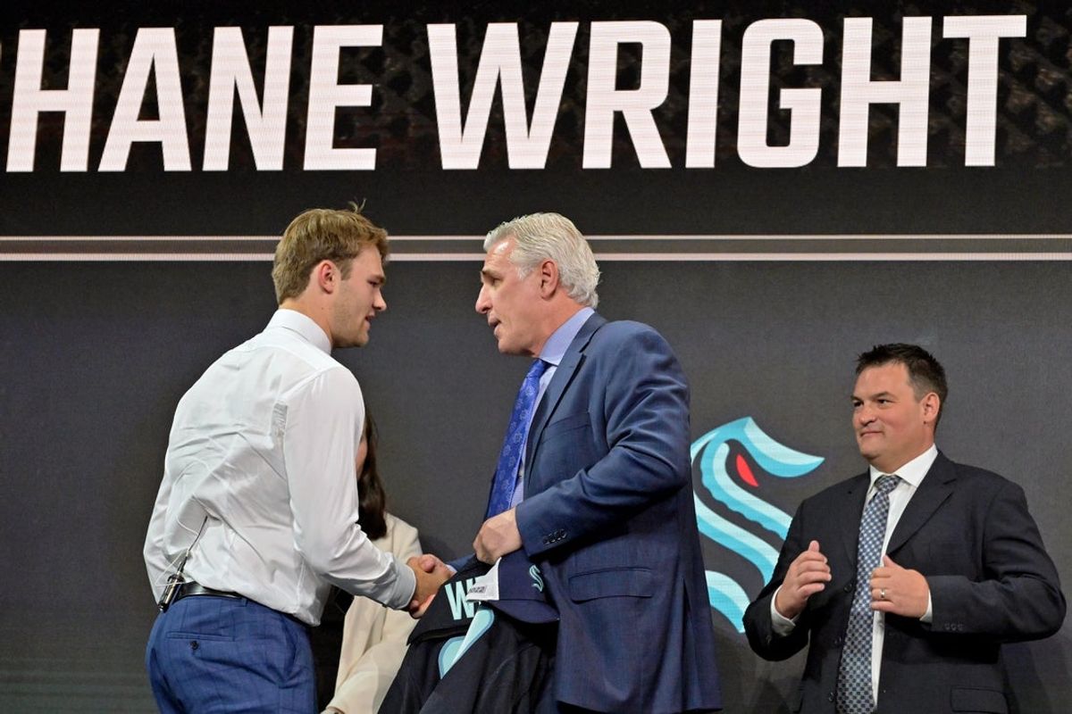Jul 7, 2022; Montreal, Quebec, CANADA; Shane Wright shakes hands with Seattle Kraken general manager Ron Francis after being selected as the number four overall pick to the Seattle Kraken in the first round of the 2022 NHL Draft at Bell Centre. Mandatory Credit: Eric Bolte-Imagn Images
