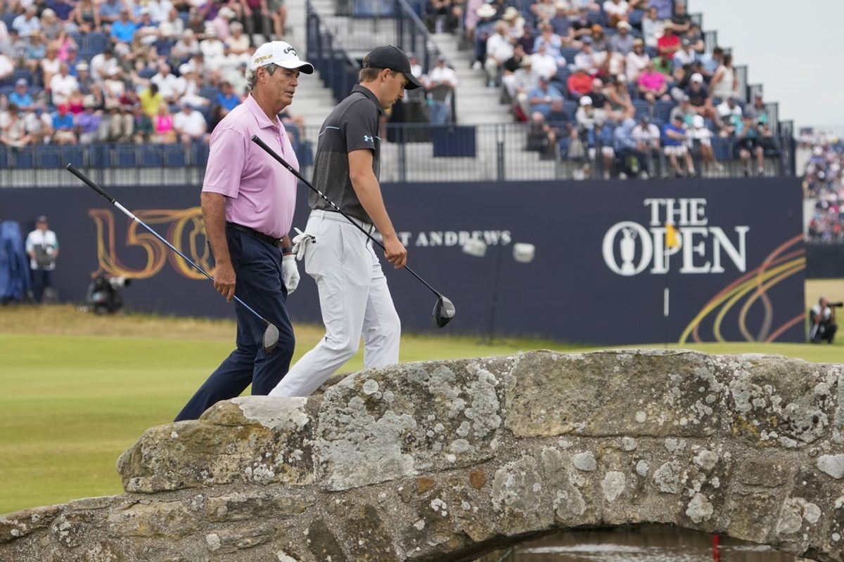 Jul 11, 2022; St. Andrews, Fife, SCT; Ian Baker-Finch (left) and Jordan Spieth cross the Swilcan Bridge on the 18th fairway during the Celebration of Champions at the 150th Open Championship golf tournament at St. Andrews Old Course. Mandatory Credit: Michael Madrid-Imagn Images