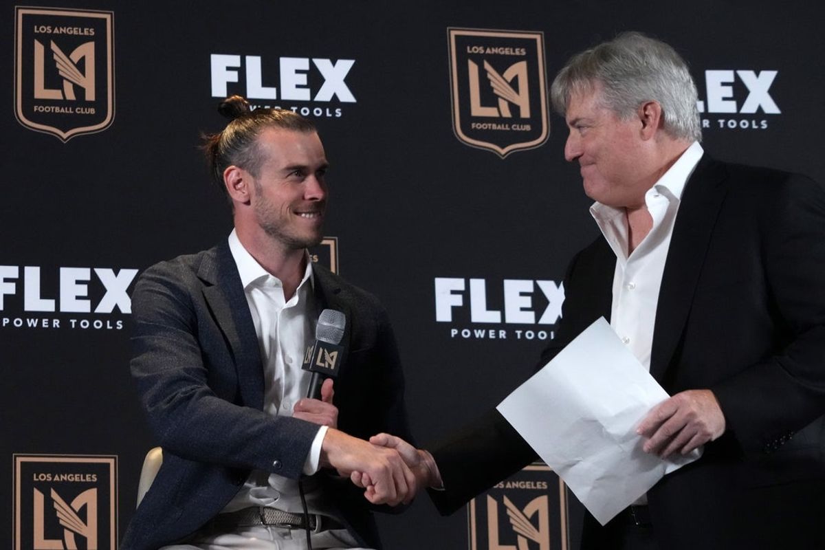 Jul 11, 2022; Los Angeles, CA, USA; LAFC forward Gareth Bale (left) shakes hands with lead managing owner Larry Berg during introductory press conference at Banc of California Stadium. Mandatory Credit: Kirby Lee-Imagn Images