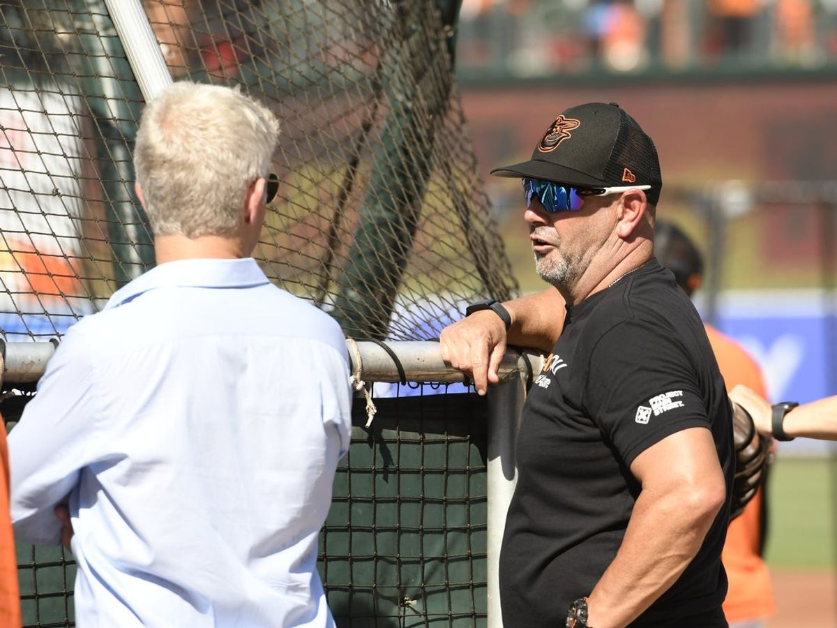 Baltimore Orioles manager Brandon Hyde (18) talks with General manager Mike Elias (left) during batting practice prior to a game between the Baltimore Orioles and the New York Yankees at Oriole Park at Camden Yards. Mandatory Credit: James A. Pittman-Imagn Images