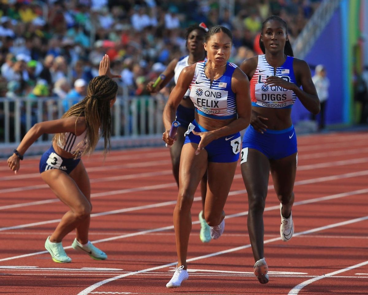 USA's Allyson Felix, center, takes the baton from teammate Talitha Diggs for the second leg of the women's 4x400 meter relay on day nine of the World Athletics Championships at Hayward Field in Eugene, Oregon Saturday July 23, 2022.

Eug 072322 Worlds 12