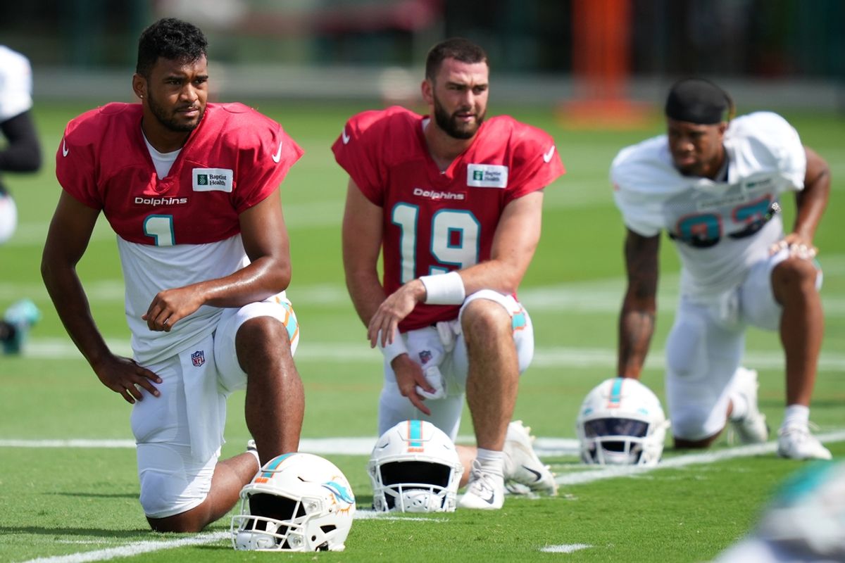 Aug 2, 2022; Miami Gardens, Florida, US; Miami Dolphins quarterback Tua Tagovailoa (1) and quarterback Skylar Thompson (19) stretch during training camp at Baptist Health Training Complex. Mandatory Credit: Jasen Vinlove-Imagn Images