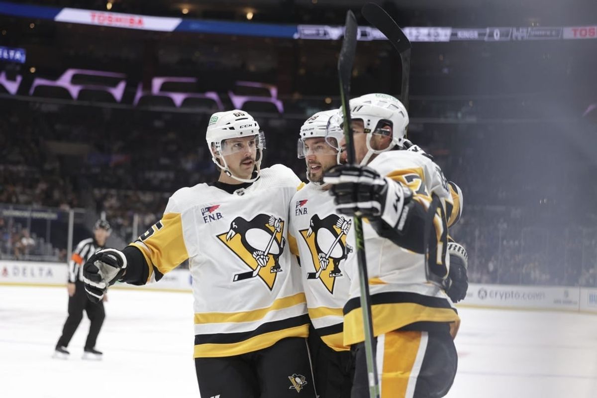 Nov 9, 2023; Los Angeles, California, USA; Pittsburgh Penguins defensemen Erik Karlsson (65), defensemen Kris Letang (58) and center Sidney Crosby (87) celebrate after a goal by center Sidney Crosby (87) in the first period against the Los Angeles Kings at Crypto.com Arena.