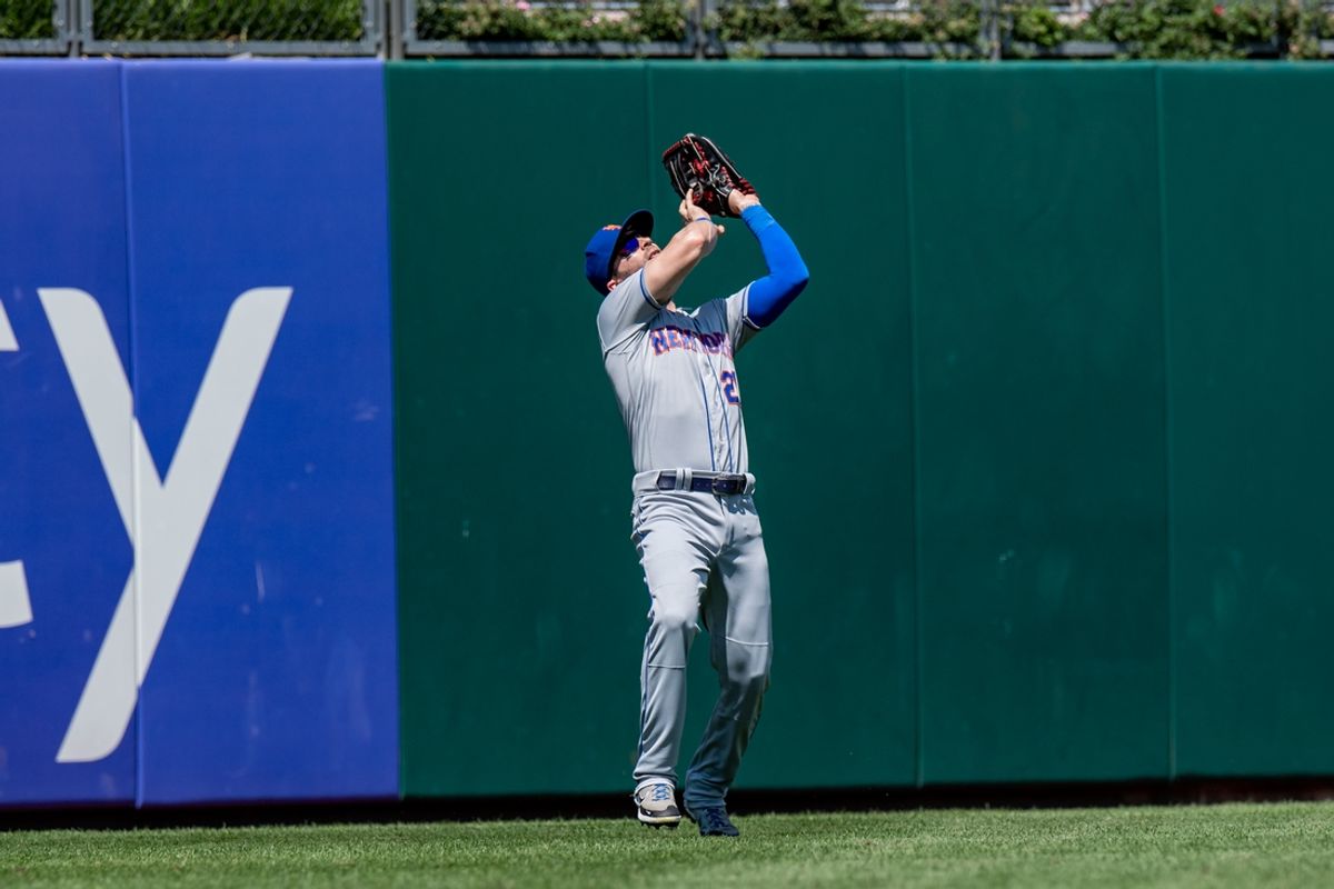 Aug 20, 2022; Philadelphia, Pennsylvania, USA; New York Mets right fielder Tyler Naquin (25) catches a fly ball against the Philadelphia Phillies during the second inning at Citizens Bank Park. Mandatory Credit: John Jones-Imagn Images