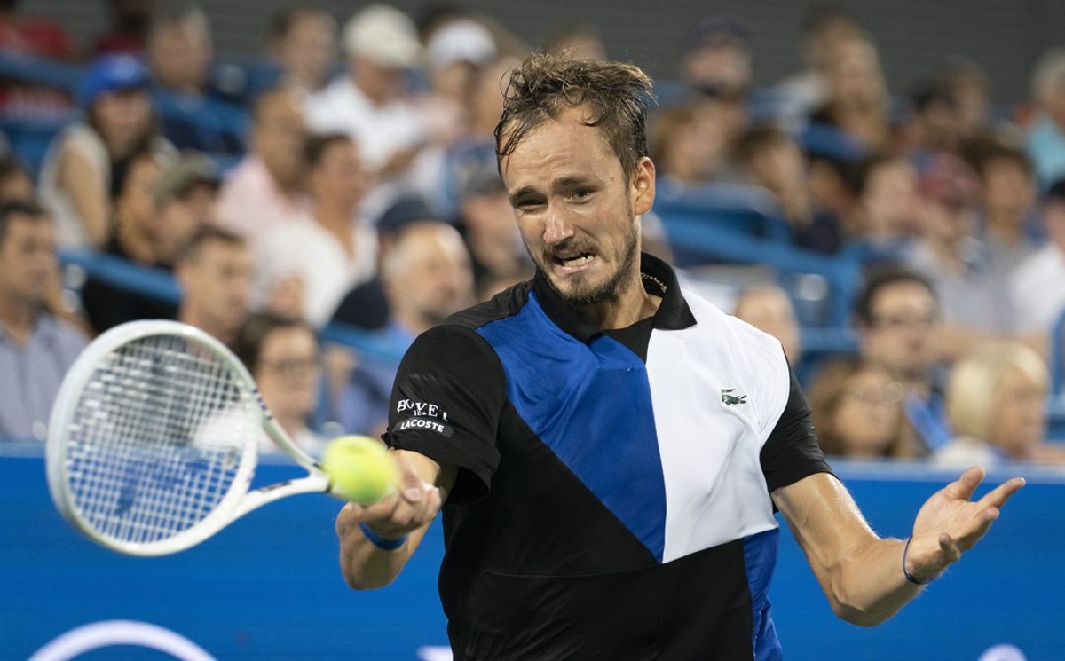Aug 20, 2022; Cincinnati, OH, USA; Daniil Medvedev (RUS) returns a shot against Stefanos Tsitsipas (GRE) at the Western & Southern Open at the Lindner Family Tennis Center. Mandatory Credit: Susan Mullane-Imagn Images