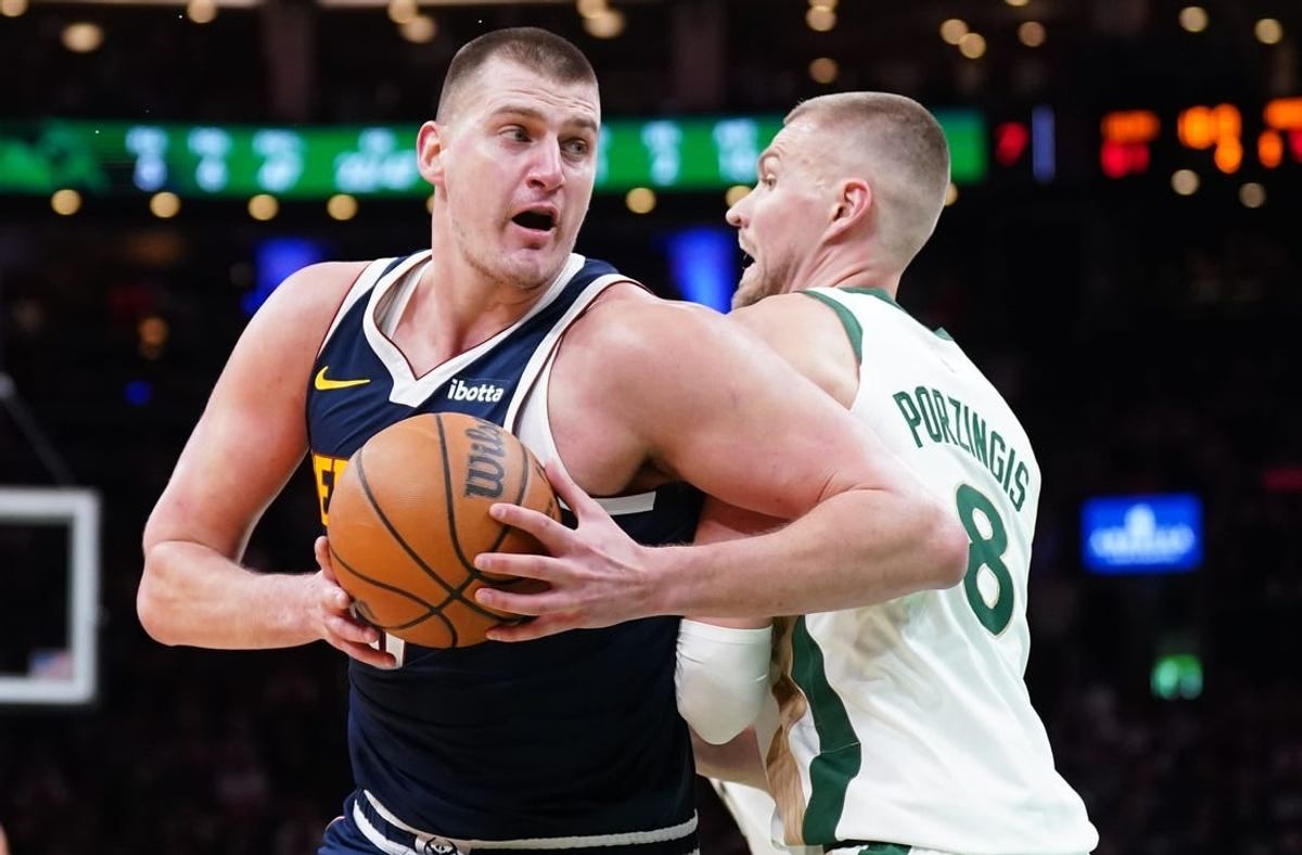 Jan 19, 2024; Boston, Massachusetts, USA; Denver Nuggets center Nikola Jokic (15) works the ball around Boston Celtics center Kristaps Porzingis (8) in the second quarter at TD Garden.